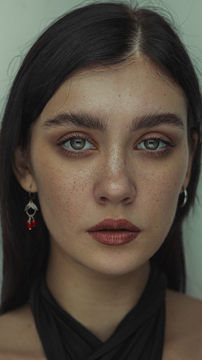 A woman with freckled hair and blue eyes
